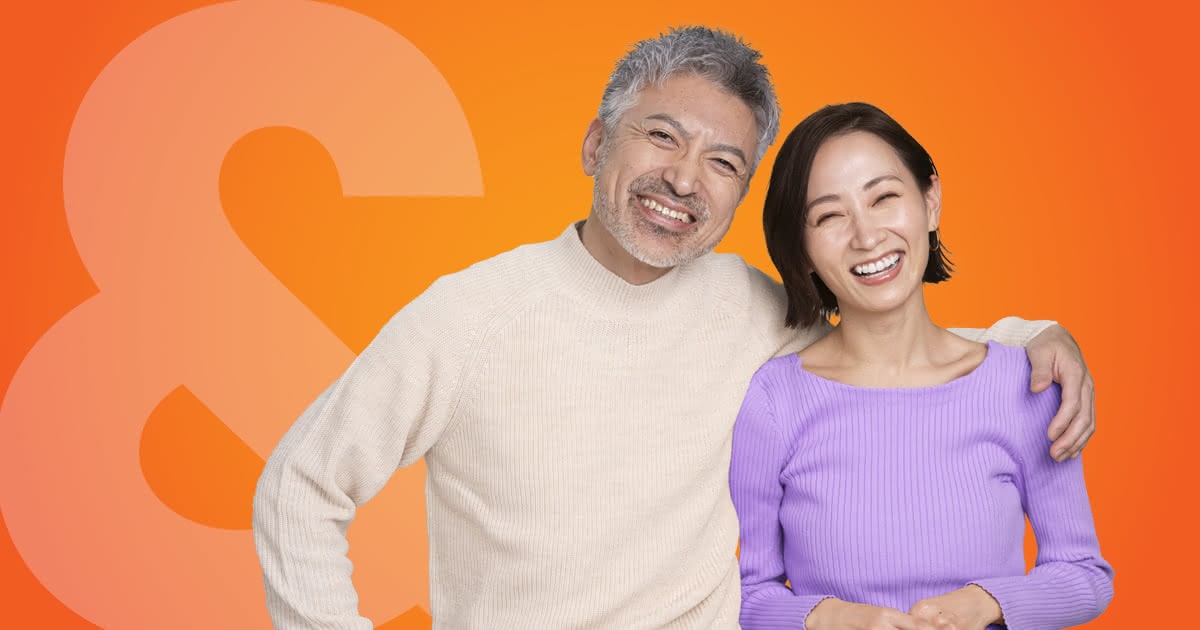 A smiling retired couple on an orange background